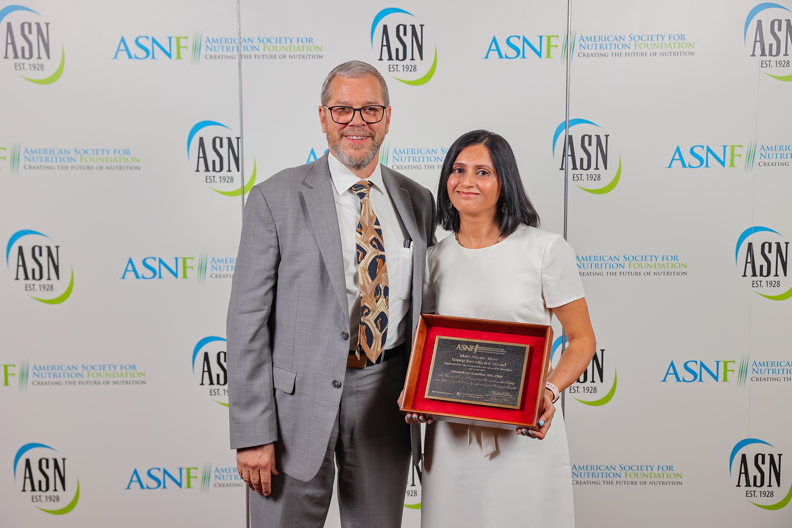 Dr. Sandhu poses with her award.