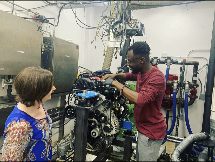 King Ankobea-Ansah and Professor Carrie Hall work on an engine.