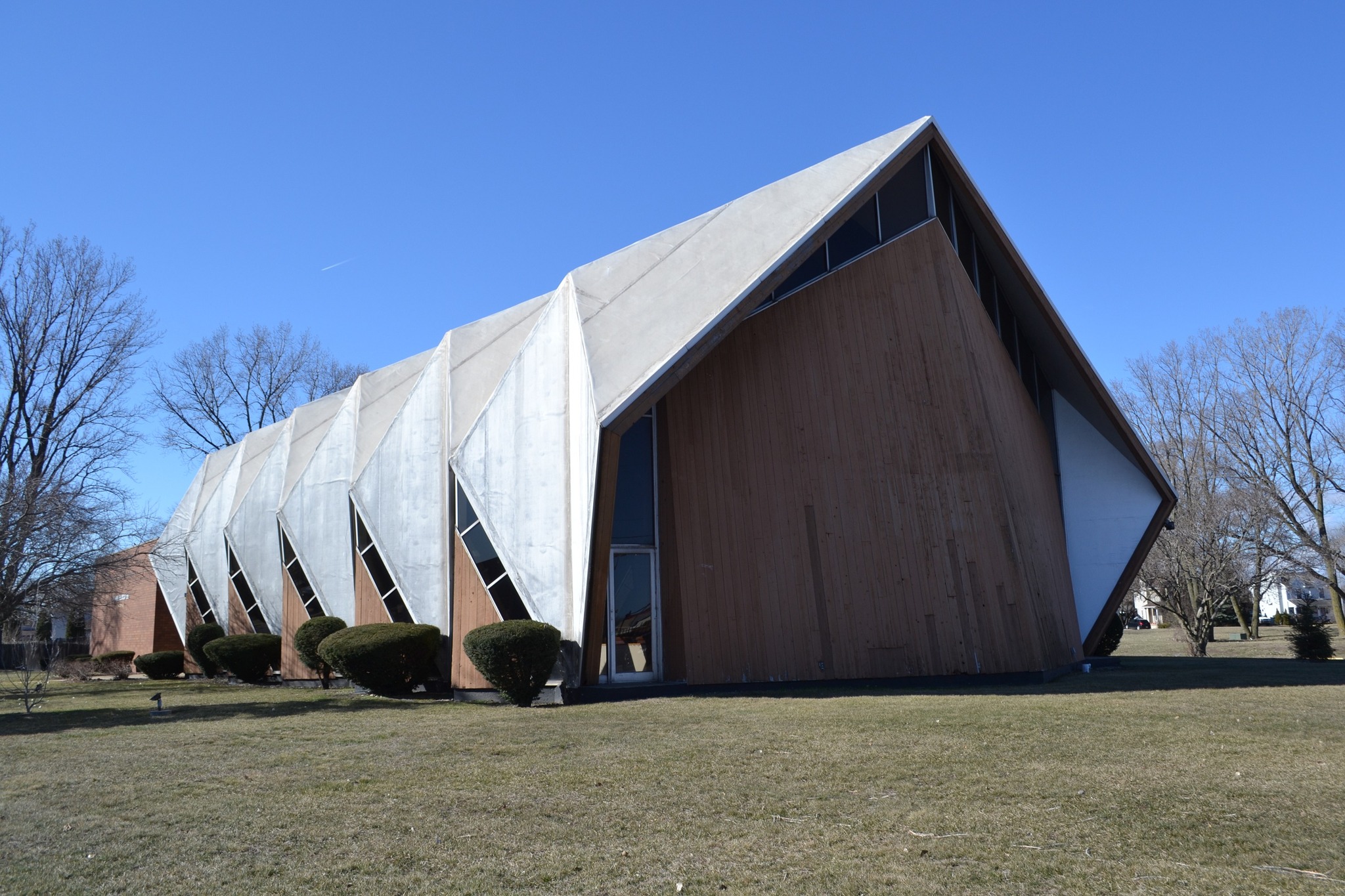 A church with a pleated roof evocative of hands in prayer.